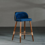 A blue dining room chair in a studio with gray walls