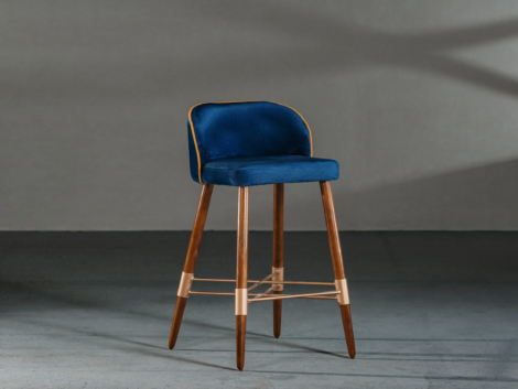 A blue dining room chair in a studio with gray walls